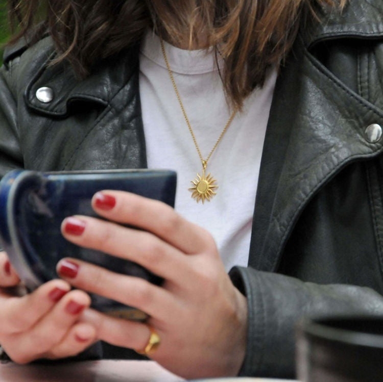 Radiant sun charm gold necklace, perfect for layering or wearing solo