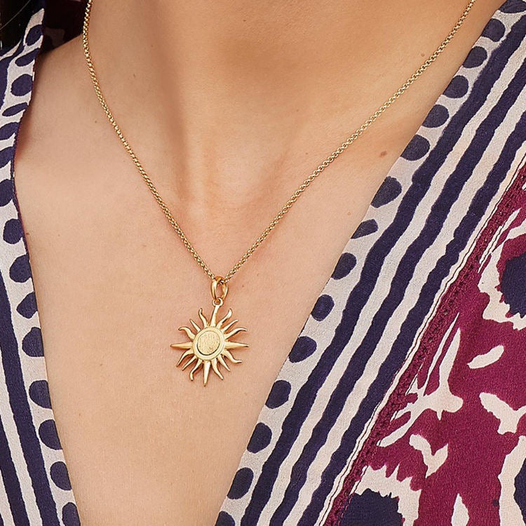Radiant sun charm gold necklace, perfect for layering or wearing solo