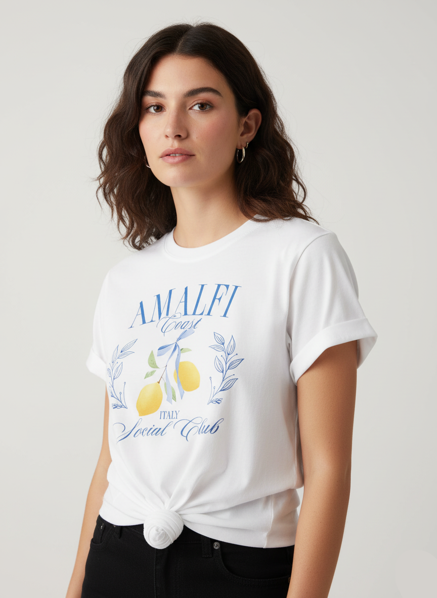 Woman wearing a white t-shirt with 'Amalfi Coast' design on a plain background
