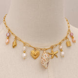 Freshwater pearl necklace with ocean-themed charms, perfect for beach or city wear