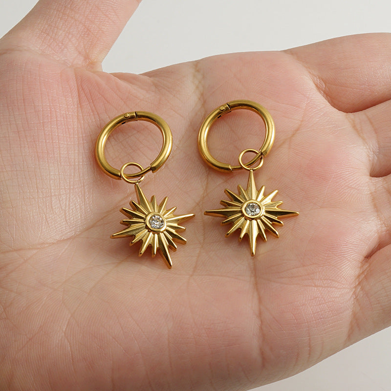 Gold hoop earrings with hexagon star charm and delicate stone