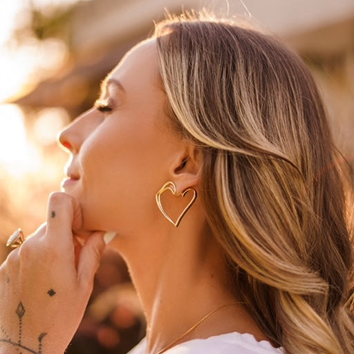a women wearing a hear earring