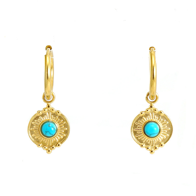 Gold hoop earrings with sunburst design and vibrant turquoise gemstone
